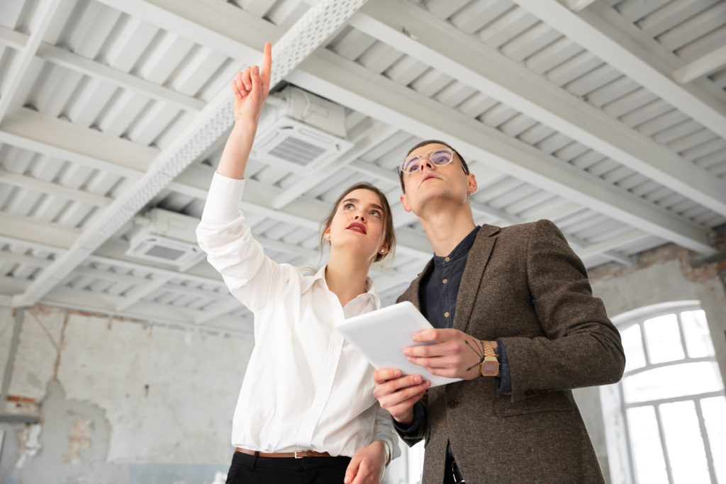 female estate agent showing new home young man after discussion house plans moving new home concept