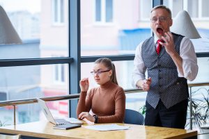 girl business lady sitting wooden table with laptop working teacher boss mentor indicates her mistakes school new business development concept